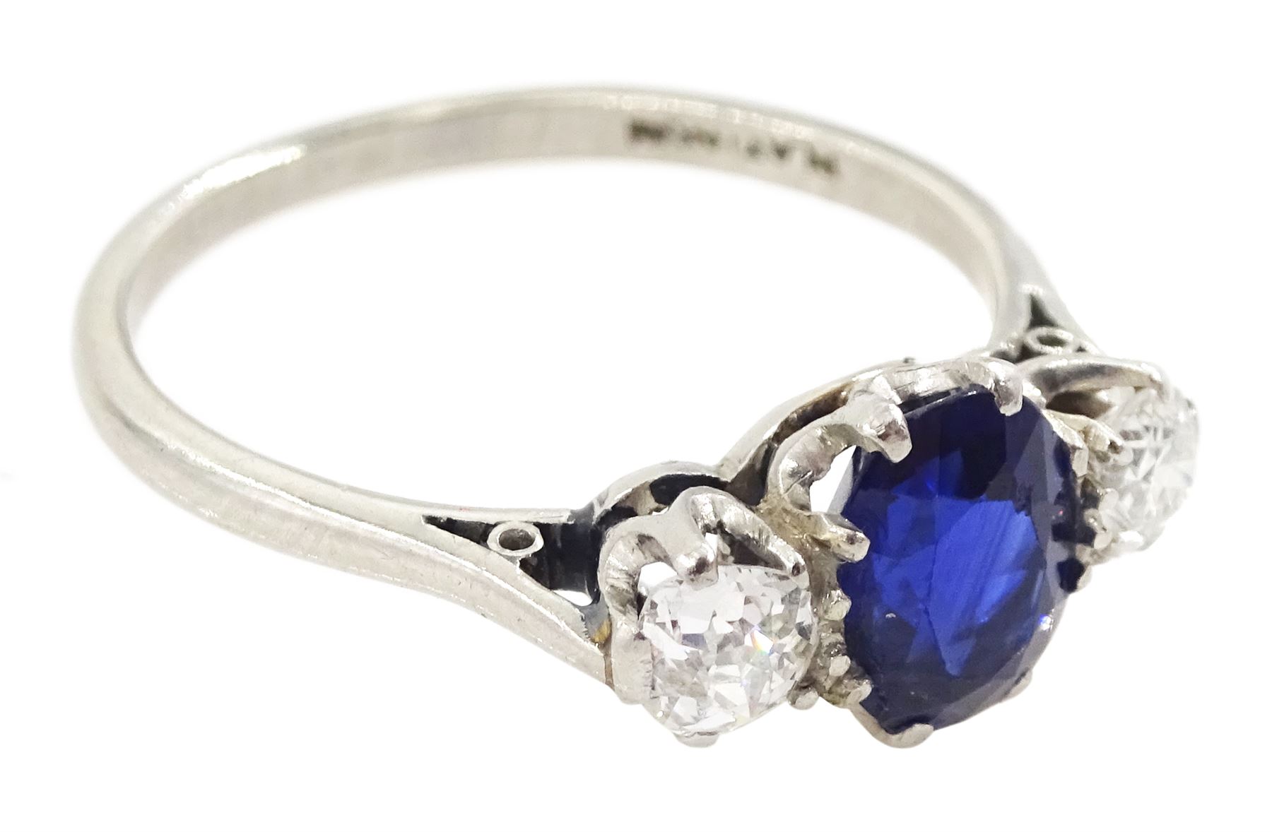 Early 20th century platinum three stone oval cut sapphire and old cut diamond ring, stamped, sapphire approx 1.10 carat, total diamond weight approx 0.30 carat