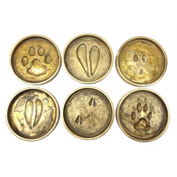 Rowland Ward (British Taxidermist: 1848–1912), set of six African Animal brass paw print coasters, comprising Jackal, Klipspringer, Damaraland Dik Dik, Bushbuck, Impala and Serval Cat, signed beneath, D8cm   