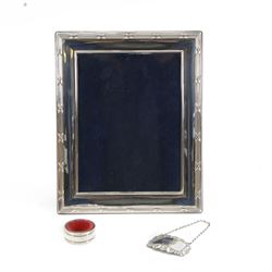 Modern silver mounted photograph frame, of rectangular form with reed and ribbon border, hallmarked Carr's of Sheffield Ltd, Sheffield 2000, together with a silver napkin ring and a silver Port decanter label, both hallmarked, frame H26cm x 21cm