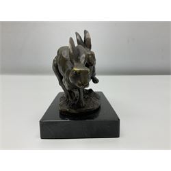 Bronze figure group, modelled as two hares in chase, upon a naturalistic base signed Nick and with foundry mark, raised upon a rectangular marble base, overall H12cm. 