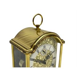 A 20th century brass cased Kieninger (German) chiming mantle clock with a break arch top and three glazed panels, polished sheet brass dial with applied  brass fretwork and a silvered chapter ring, Roman numerals, minute track, steel serpentine hands and seconds dial, three-train spring driven 8-day movement with Westminster, St Michael and Whittington chimes on 8 gong rods, 9 jewel lever platform escapement.  With key. 