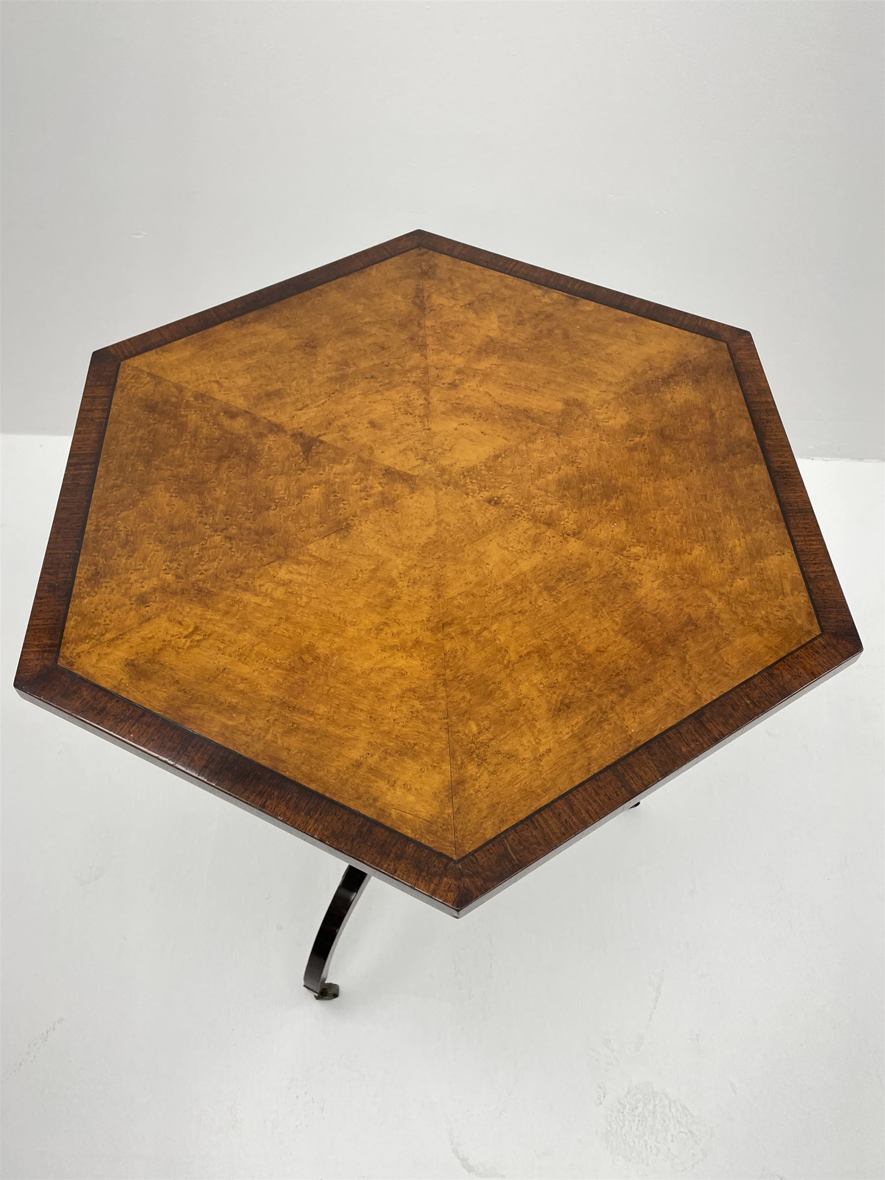 Regency style birdseye maple and rosewood tripod table, hexagonal tilt top with segmented veneer and banding, tapered hexagonal column on three splayed serpentine supports, brass cups and castors 
