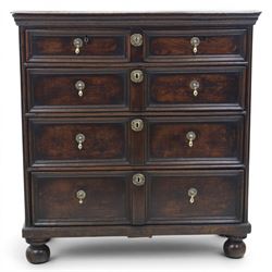 Late 17th century moulded front oak chest of drawers, rectangular plank top. above two banks of four graduated drawers, central escutcheons and drop handles, on squat bun feet
