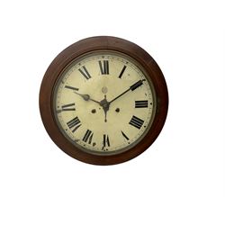 An early 20th century English wall clock with a circular 16” mahogany wooden bezel, 12” painted steel dial with Roman numerals and minute track, steel spade hands within a flat glass and spun brass bezel, eight-day rack-striking spring driven movement striking the hours on a coiled gong, with case side door and pendulum regulation door to base, dial inscribed with the trademark BUC Ltd . 
( British United Clock Company 1885-1909)
With pendulum and key.



