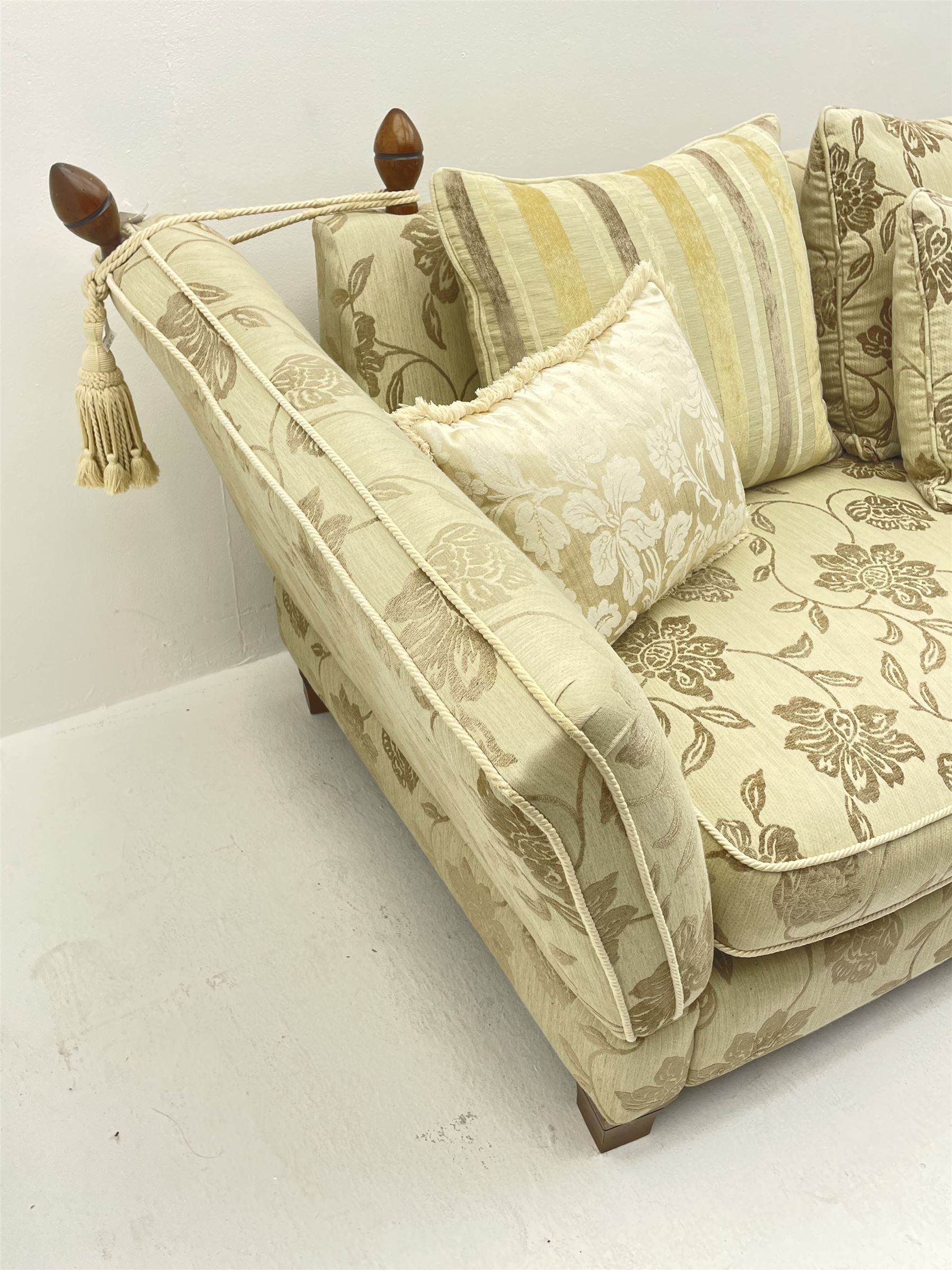 Grande Knole drop arm three seat sofa upholstered in pale fabric with raised floral pattern, with feather scatter cushions