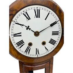 A late 19th century American drop dial wall clock in a walnut case, with an 8-day striking movement striking the hours and half hours on a coiled gong, with a 16” wooden bezel and a painted 12” dial, Roman numerals and minute track with “ace of clubs” steel hands, spun brass bezel and flat glass, with pendulum regulation and viewing door. With key and pendulum.