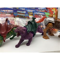 Thirty-one Masters of the Universe He-Man figures re-bagged on original backing cards;  two others lacking backing cards; boxed Modulok figure; bag of weapons and accessories; Roton, two horses and two battle cats; 1986 & 1987 Annuals; Ladybird and other story books; Panini sticker album; instructions etc