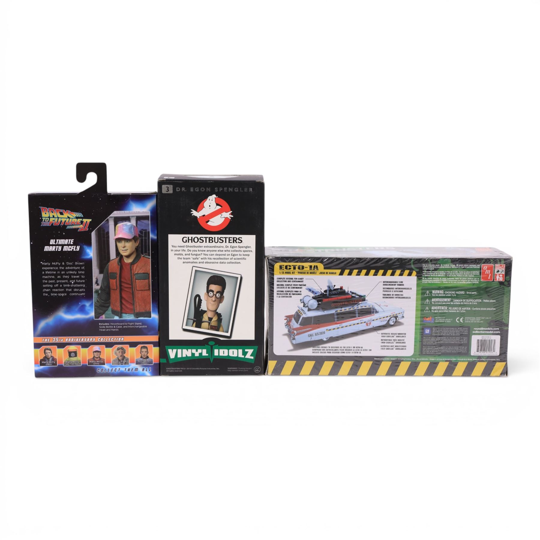 Neca Back to the Future Marty Mcfly figure, AMT Ghostbusters Ecto-1A 1:25 scale model kit and Vinyl Idolz Egon Spengler figure, all boxed