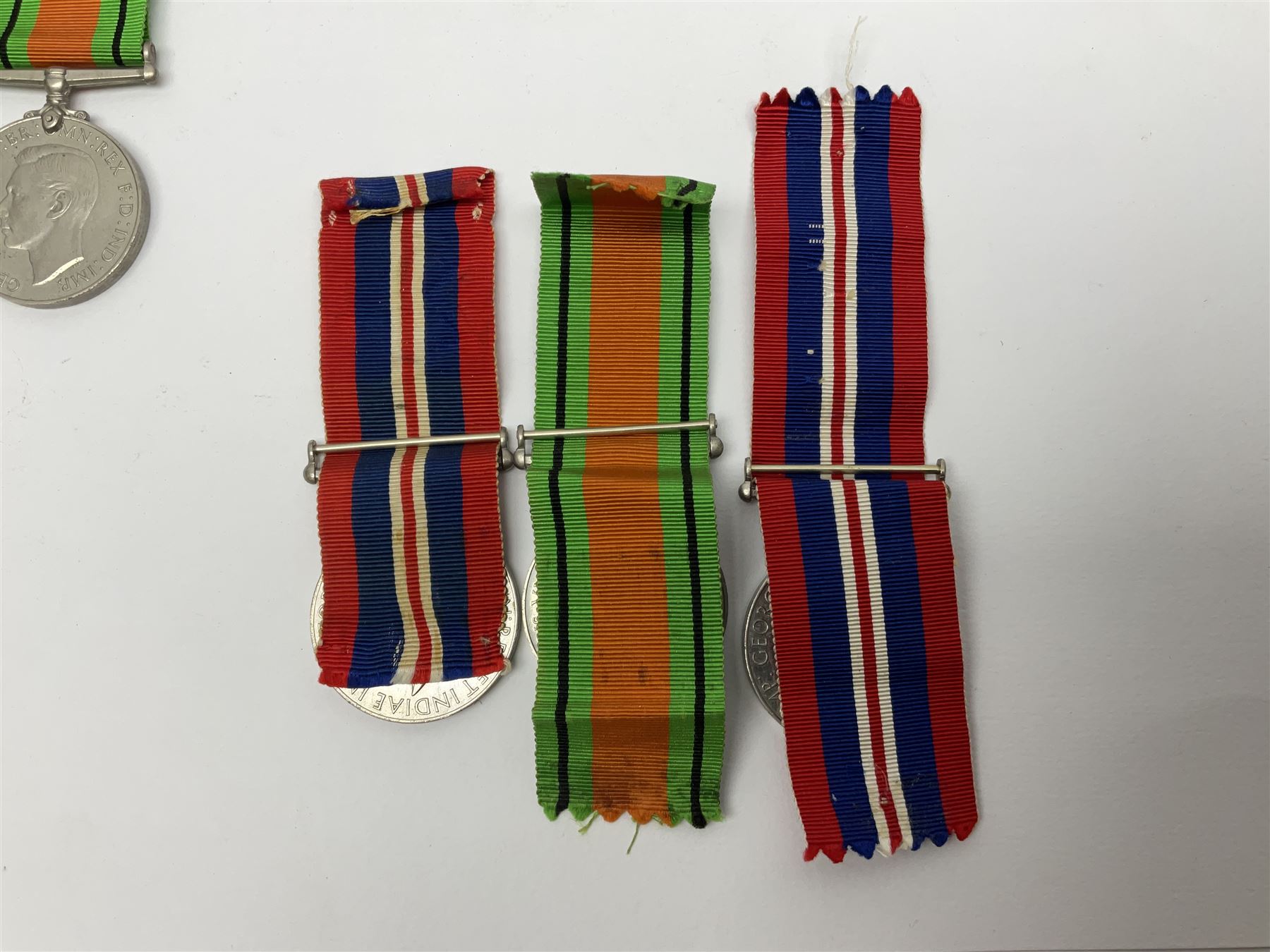Twelve WW2 medals comprising four 1939-1945 war medals, four Defence medals, three 1939-1945 Stars and Africa Star; all with ribbons; some as groups in two issue boxes with slips