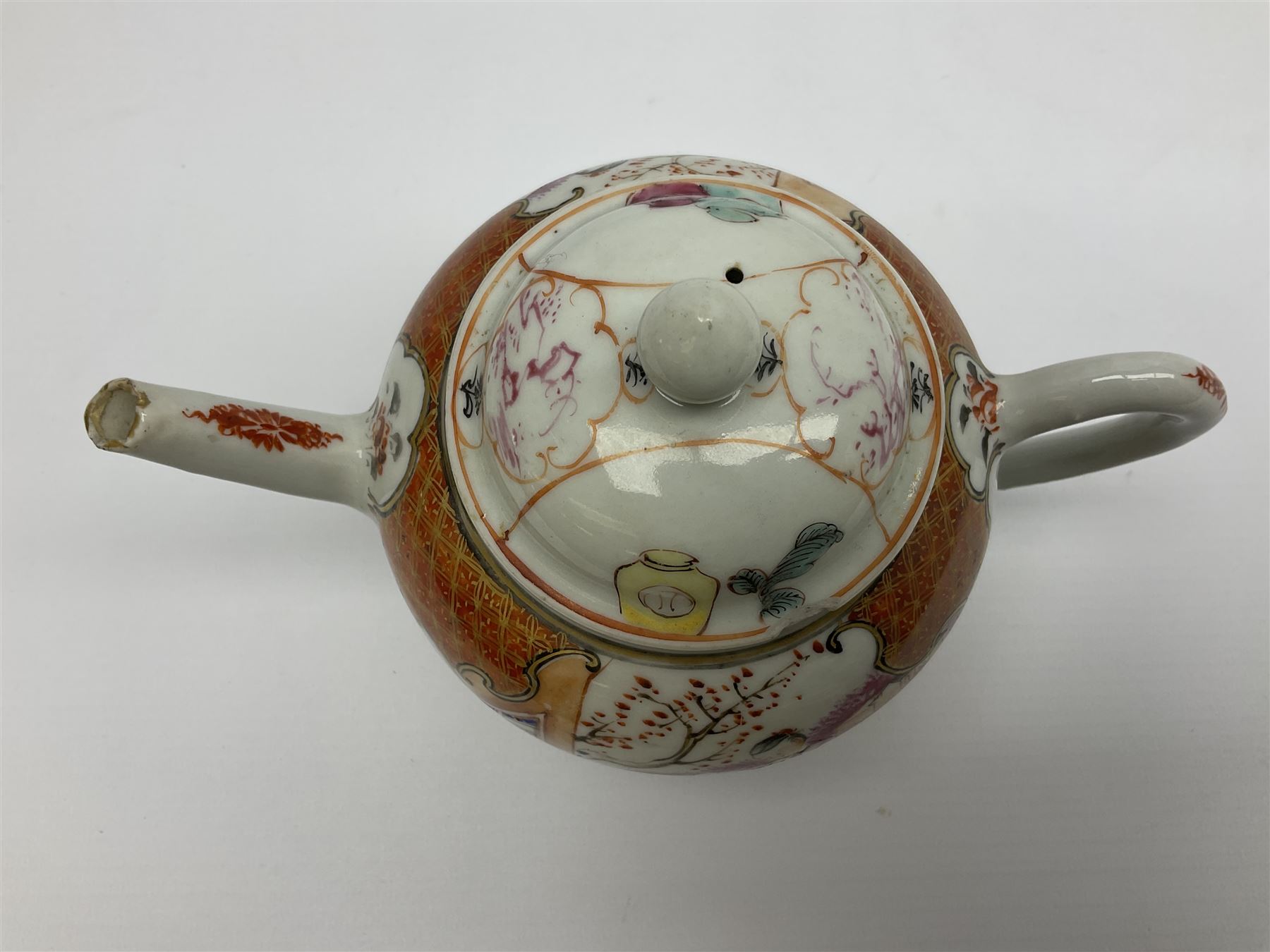 Two late 18th/early 19th century Chinese export teapots, the largest example of globular form with curved handle and straight spout, decorated in the Mandarin style with figural scenes surrounded by red scale reserves, H13.5cm, the second smaller example decorated in underglaze blue with two musicians in a landscape set with willow tree and fence, H10.5cm


