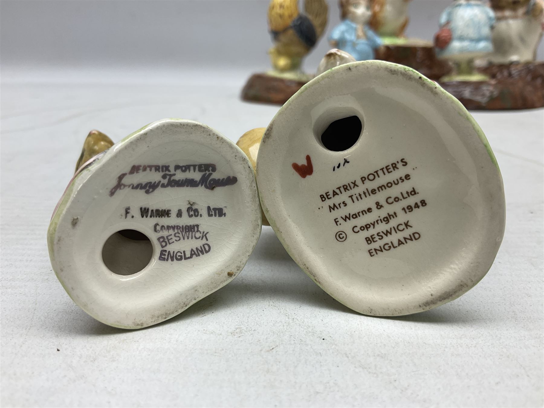 Seven Beswick Beatrix Potter figures, comprising Sally Henny Penny, Johnny Town-Mouse, Mrs Tiggy-Winkle, Mrs Tittlemouse, Tom Kitten, Pig-Wig and Squirrel Nutkin, together with a Beswick tree trunk display stand, stand L30cm