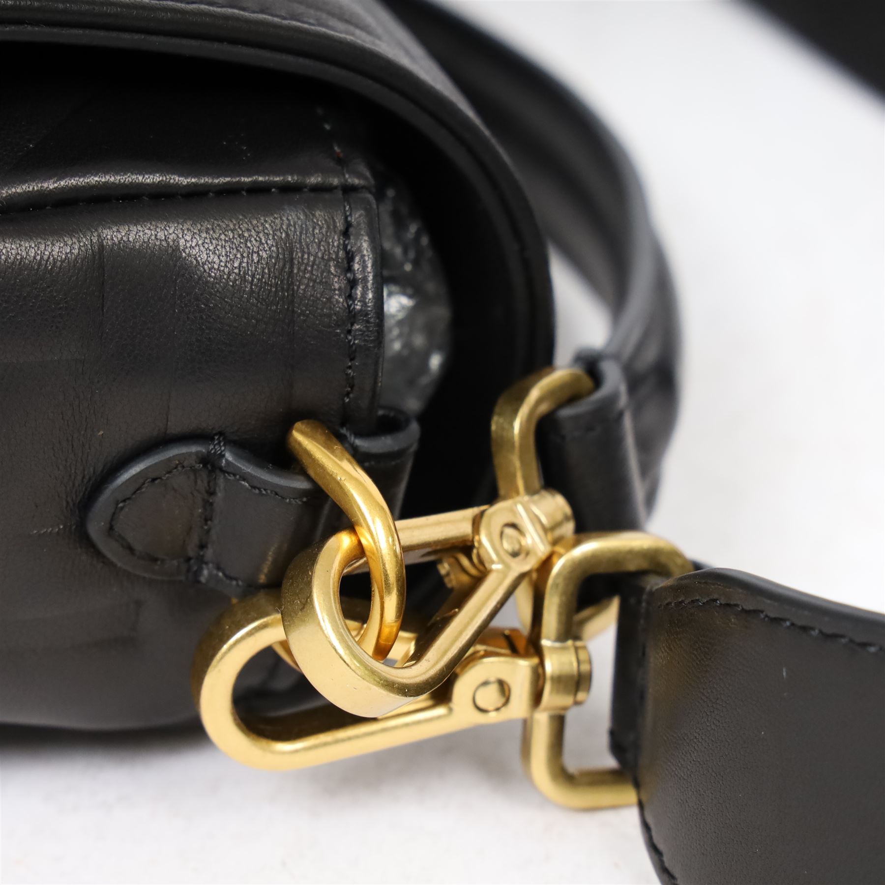 Fendi Baguette shoulder bag, black nappa leather with embossed FF monogram and quilted panels, the front flap secured by a gold-tone FF logo magnetic clasp engraved Fendi Made in Italy, with detachable leather shoulder strap and gold-tone hardware, interior leather tab stamped 'Baguette Fendi Made in Italy', together with original Fendi dust bag and box, W27cm D7cm H15cm