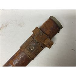 George V 1897 pattern Infantry officers sword, the 82cm single fullered blade with traces of etched detail and George V crown cipher, the ricasso marked Hawksworth Sheffield, pierced half basket hilt with George V cypher, wire-bound fish-skin grip with brass pommel and backstrap; in leather scabbard L102cm overall; together with two sectional gun cleaning rods; swagger stick made of leather strips etc