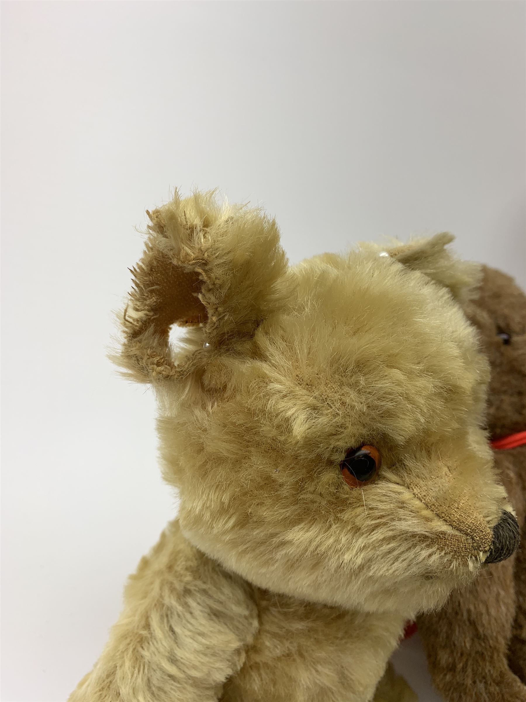 Four 1950s English teddy bears including a Chad Valley brown alpaca wool bear with swivel jointed head, glass type eyes, vertically stitched nose and mouth and jointed limbs H15