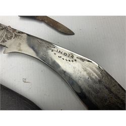 Indian kukri with 29cm curving steel blade and nickel mounted horn grip; in leather covered scabbard with one skinning knife L42cm overall; Hitler Youth knife with scabbard in relic condition; and three African graduated knives each with crudely carved wooden grips and painted leather covered scabbards (5)