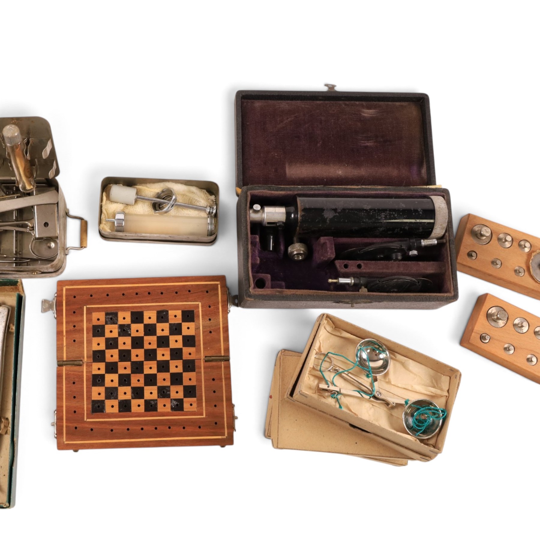 Field medical equipment, including scalpels, syringe, small weights and scales, ophthalmoscope, etc, contained within a steel uniform case