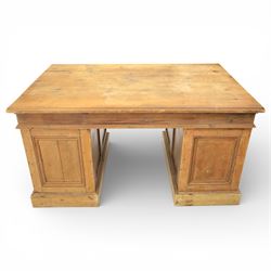 Late 19th century Victorian pine twin pedestal desk, rectangular plank top above an arrangement of seven drawers with brass swan neck handles, each pedestal fitted with one drawer above a double height drawer, raised on plinth bases with panelled sides