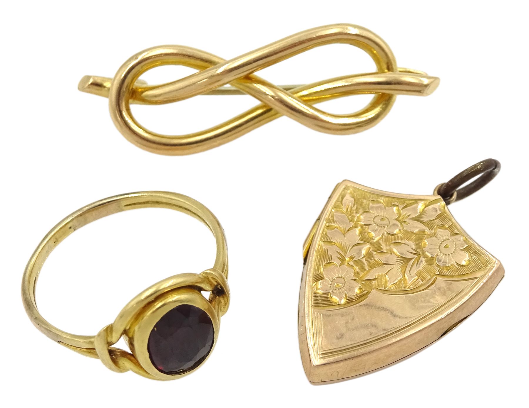 Edwardian 9ct gold shield design locket pendant, with bright cut foliate decoration, Birmingham 1908, gold single stone garnet ring and a 14ct gold knot brooch