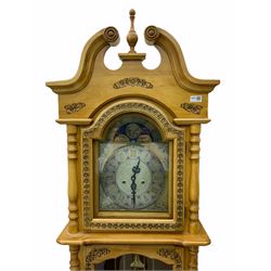 21st century replica longcase clock by “Wood & Son” in a incised light wood case with a swans neck pediment and finial, turned columns flanking a glazed broken arch hood door, trunk with a full length glazed door on a short stepped plinth, visible lyre pendulum with dummy chains and weights, 31 day going barrel movement striking the hours and half hours, brass and silver effect dial with roman numerals and decorative steel hands, faux (non- working) moon dial to the arch.