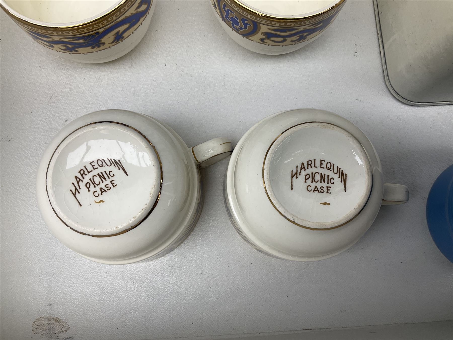 Vintage Harlequin picnic case, with tin sandwiches boxe, ceramic cups, plates, bowls and flatware for four settings, L48cm, H30cm