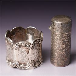 Small glass scent bottle with silver and red enamel cover, Edwardian silver cased scent flask with engraved decoration, heptagonal silver napkin ring, pair of small silver barrel shape salts, glass pepperette with silver and mother of pearl cover, small silver stone set fork by William Robb and a silver salt spoon