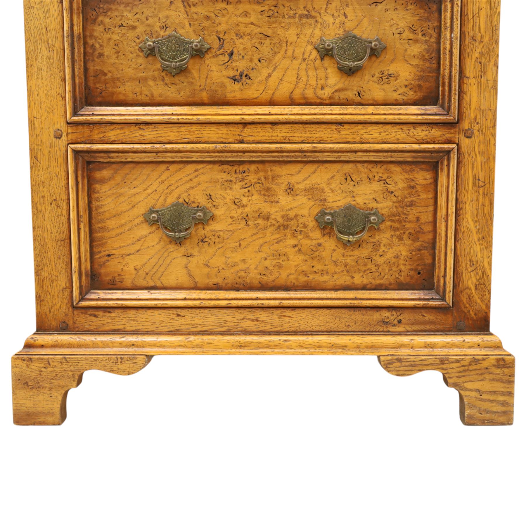 Small 20th century burr oak chest, the figured top over three graduated drawers with moulded fronts and pierced brass handles, on shaped feet