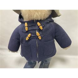 Pair of Paddington Bear teddies with amber eyes, the first example having a brown felt hat, red coat and blue PB boots with original label; the second having a grey felt hat, blue coat and blue Dunlop boots, tallest H51cm 
