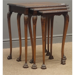  Reproduction nest of three edge banded mahogany tables, acanthus carved cabriole supports, claw feet W53cm, H61cm, D38cm  