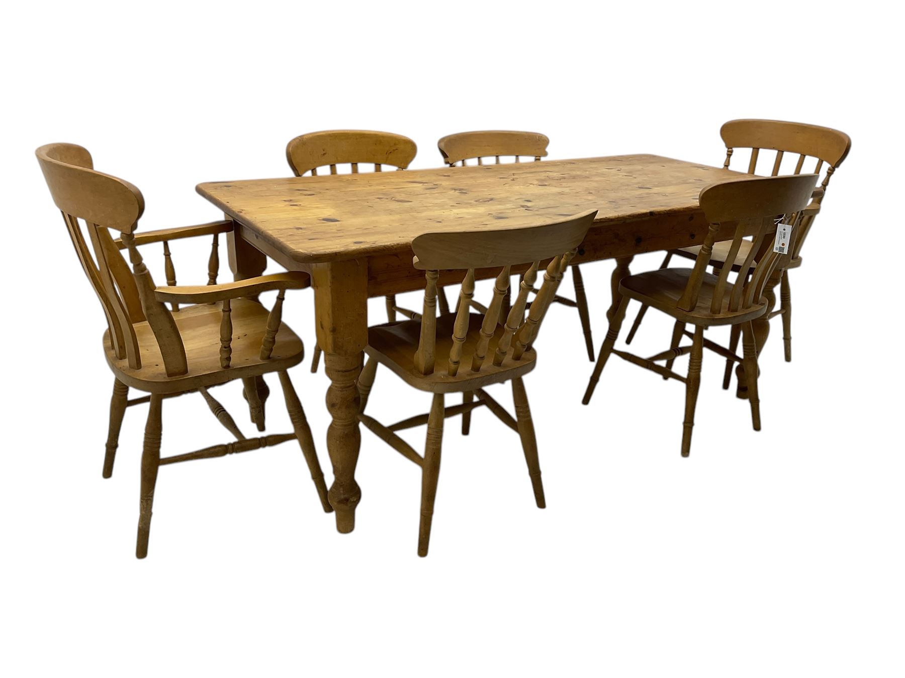 Pine farmhouse dining table, rectangular top with rounded corners, raised on turned supports; together with a set of six (4+2) spindle-back dining chairs