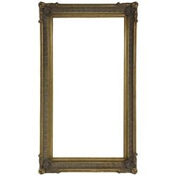 Large bevelled mirror in swept gilt frame, the frame decorated with repeating anthemion motif, each corner set with shell motif and trailing foliage
