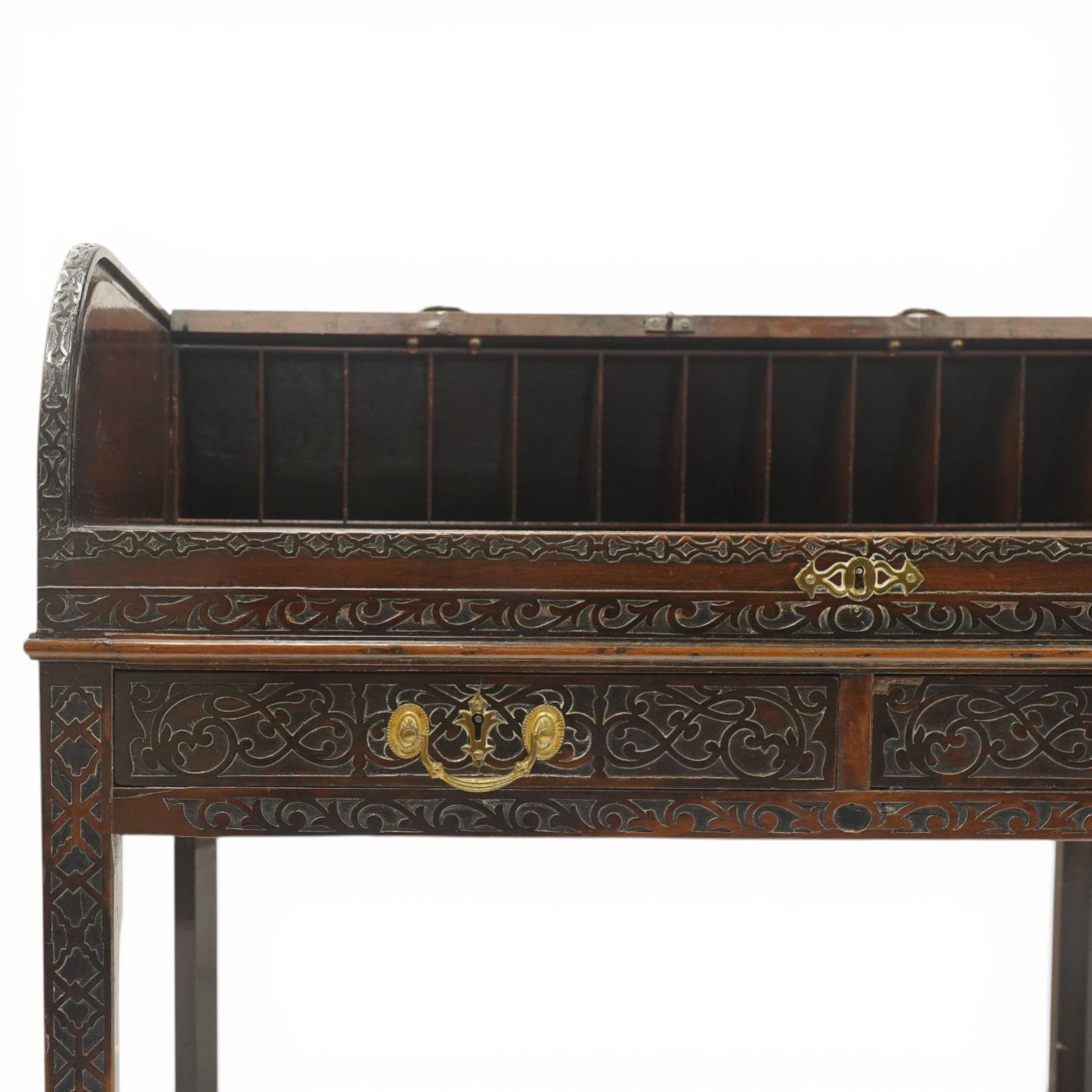 Late 18th century George III mahogany Chippendale design cylindrical roll-top desk carved profusely with geometric and foliate blind-fretwork throughout, the tambour-roll top opening to reveal pigeon holes over an inset red leather writing surface, fitted with two frieze drawers below, raised on square supports with inner chamfer terminating to brass castors, circa 1780s