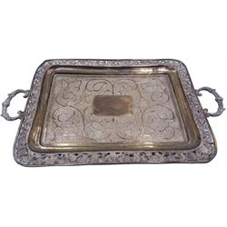 Silver twin handled tray, probably Indian, of rectangular form the centre with vacant rectangular panel within a stylised foliate chased surround and foliate pierced rim, including handles L38cm, approximate weight 14.29 ozt (444.5 grams)