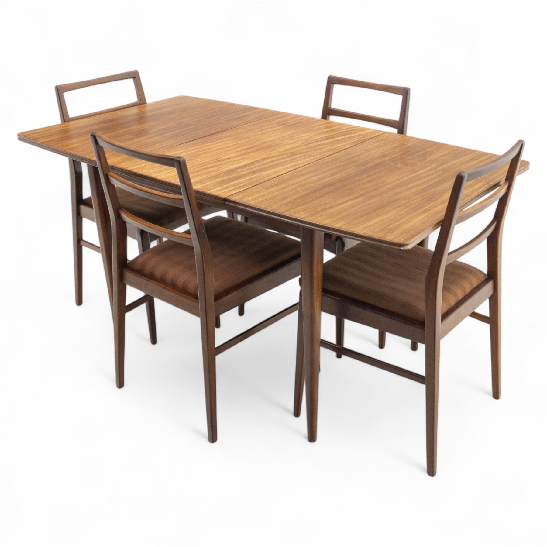 Richard Hornby for Fyne Ladye - mid-20th century afromosia teak dining table, tapered rectangular top with fluted edge and recess for spare leaf, raised on slender legs, four teak framed chairs, of ladder back design, with drop-in seat, upholstered seat, with tapered front legs and slightly raked rear legs,, table unextended width 106cm depth 79cm height 74cm with additional leaf 45cm wide- chairs width 48cm depth 41cm height 87cm 