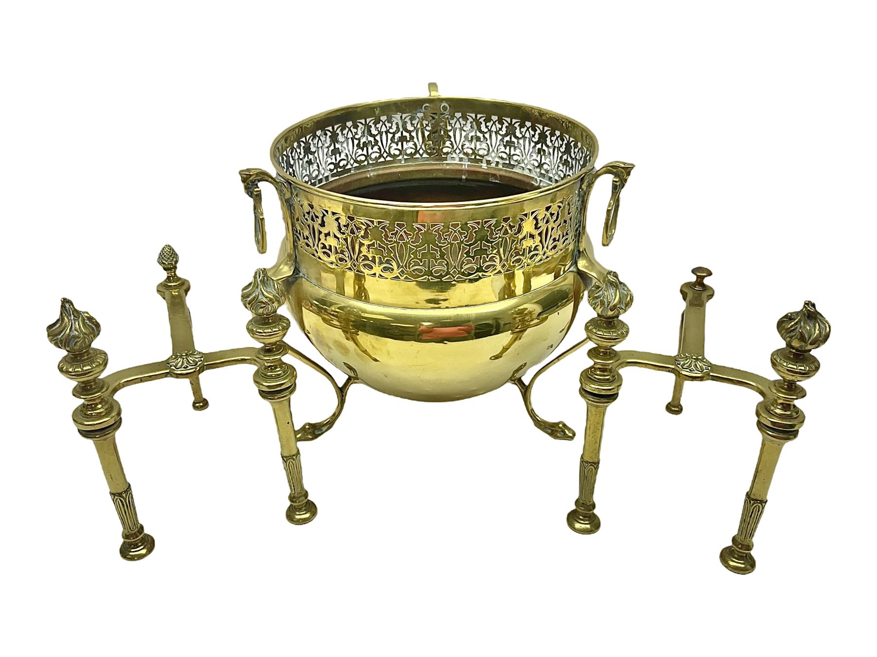 Early 20th century brass coal bucket with pierced sides, upon three pad feet, together with a pair of brass fire dogs, with flambe finials, coal bucket H27cm