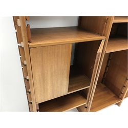 Mid 20th century teak four sectional wall unit, five upright adjustable supports working on a sliding slot joint, with two door cupboard, drawer and record compartment, W250cm, H199cm, D45cm  