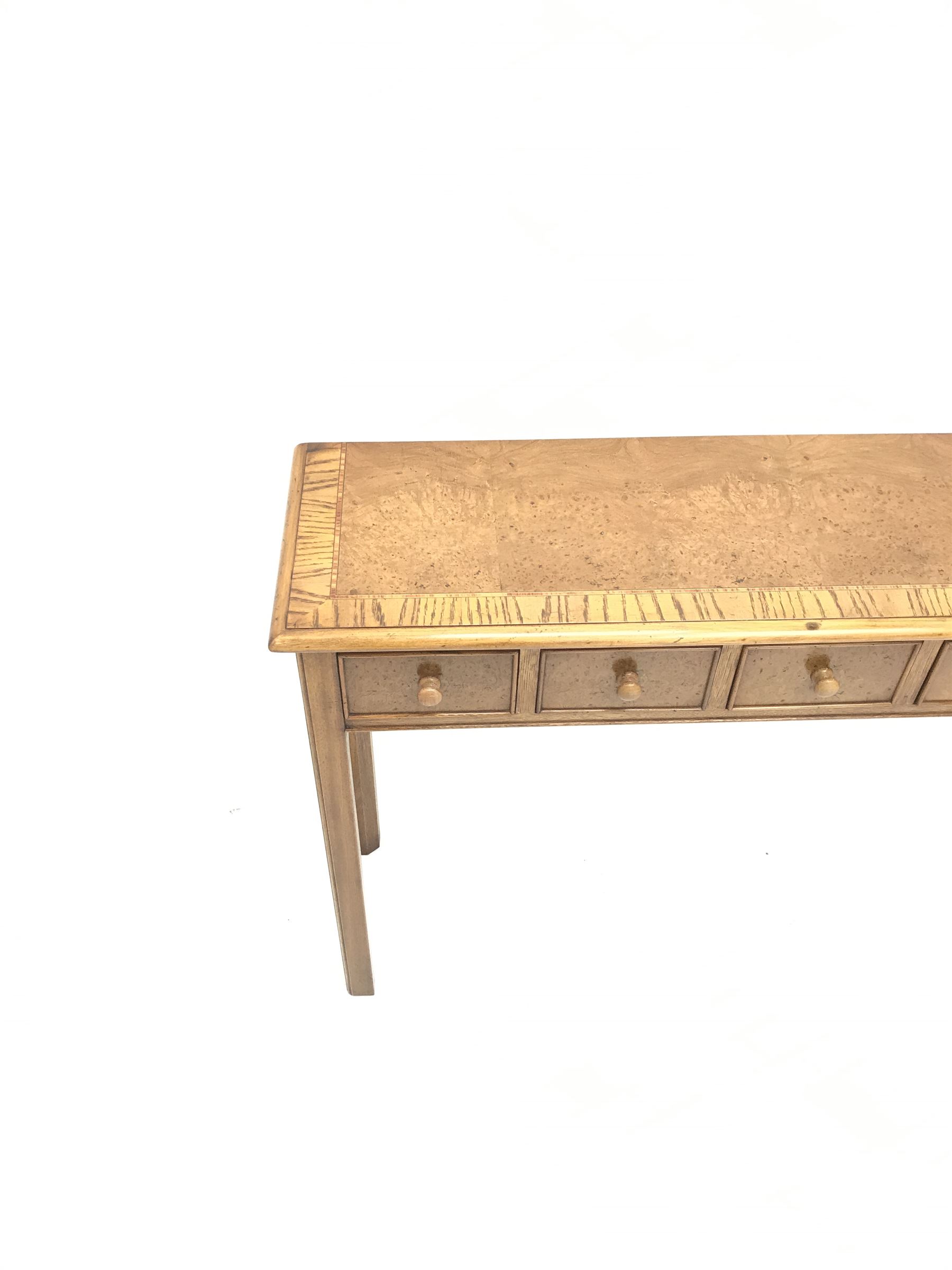 Contemporary oak, mahogany, and figured burr walnut narrow console table, moulded rectangular top with oak band and satinwood stringing, five cock beeded short drawers with turned handles, moulded and canted square supports 