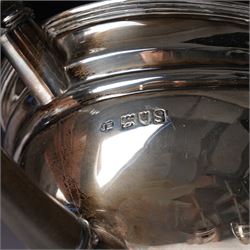 Silver three piece tea set of oval form, the teapot with ebonised handle and lift London 1913 Maker John Hunt and a pair of Victorian silver sugar tongs