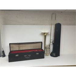 Three brass trombones comprising Elkhart Ind. USA 'CONN' model no.72H; Besson 'Concord'; and Selmer Distributed 'Lincoln'; two in carrying cases; and German B & M 'Champion' brass trumpet (4)