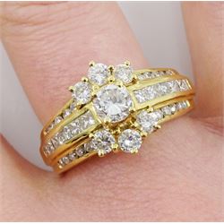 18ct gold round brilliant cut diamond cluster ring, with channel set three row round and princess cut diamond set shoulders, stamped 750