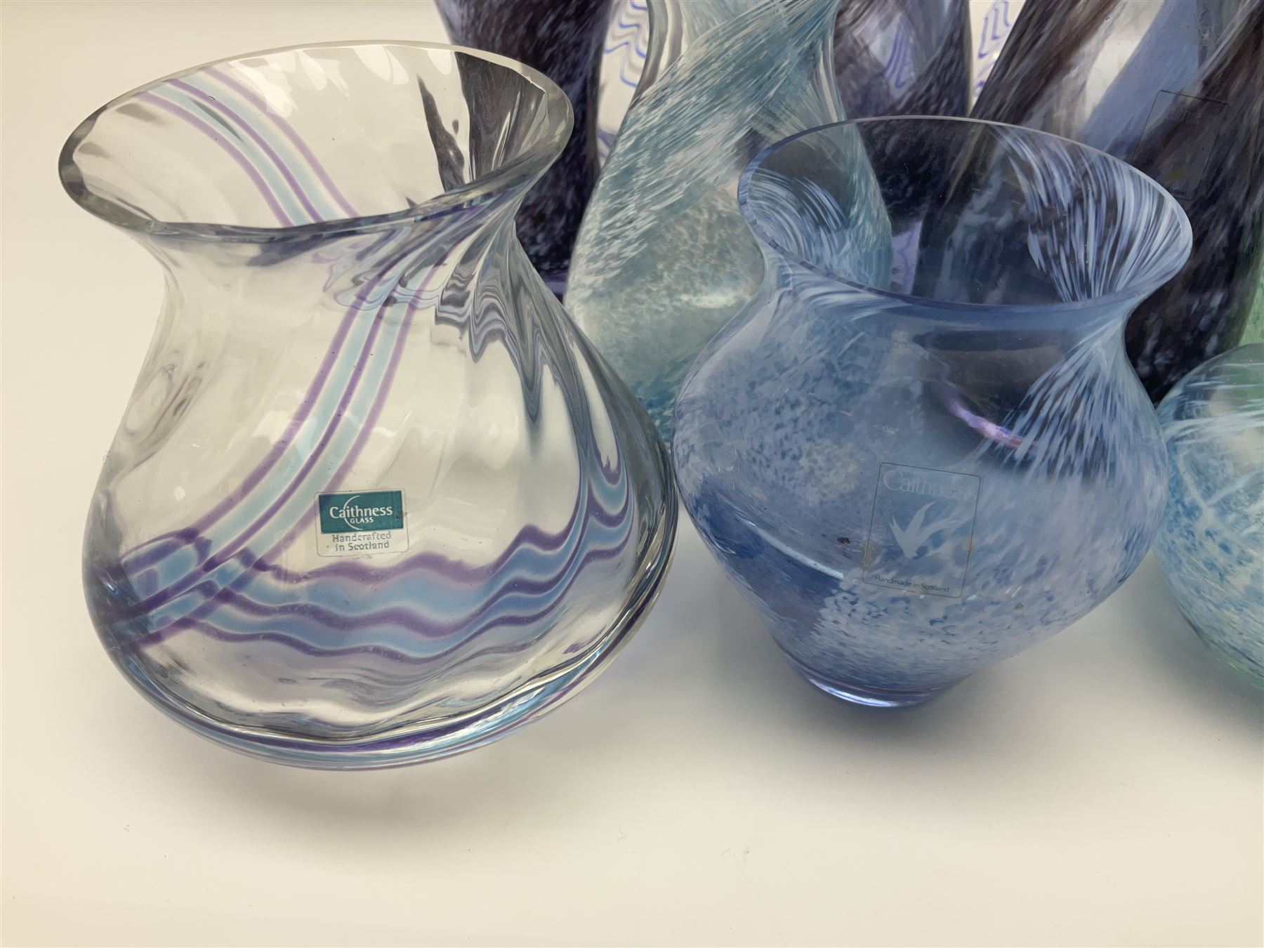 Collection of green/blue Caithness glass vases, to include mottled and swirl designs, largest 20cm (26)