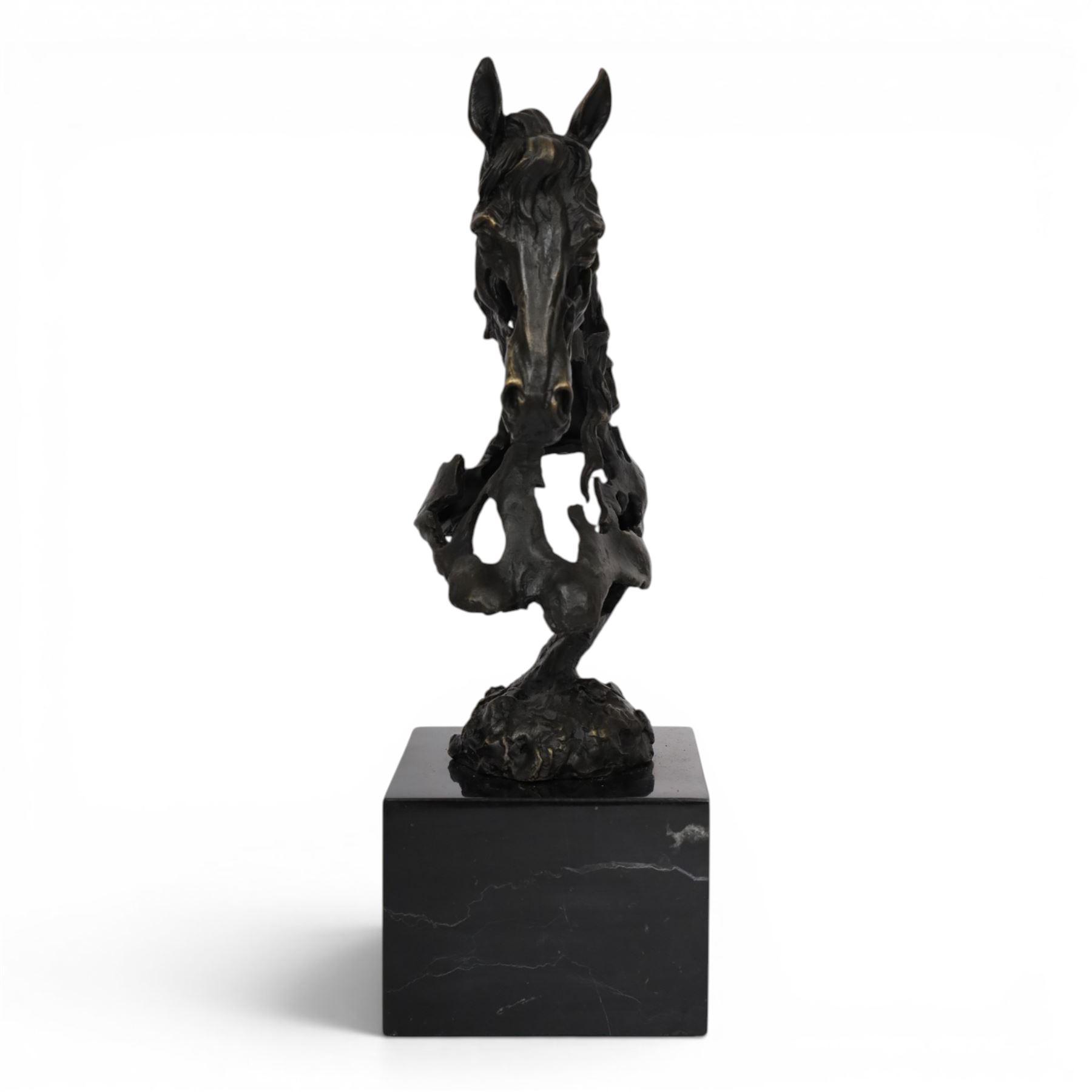 Stylised bronze model of an openwork horses head, signed Gadi and with foundry mark, raised upon black marble plinth, H41cm