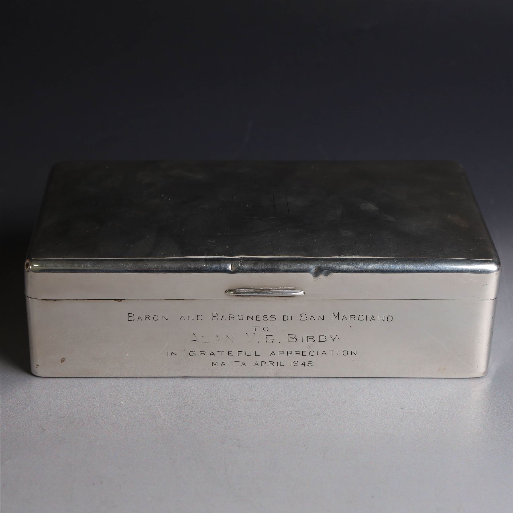 Mid 20th century silver mounted cigarette box, of rectangular form, with personal engraving to body reading 'Baron and Baroness Di San Marciano to Alan VG Bibby in grateful appreciation Malta April 1948, engraved with San Marciano family coat of arms to hinged cover, opening to reveal a softwood lined interior, hallmarked Adie Brothers Ltd, Birmingham 1946, H5cm, W16.5cm