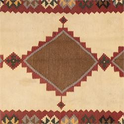 South West Persian Qashqai kilim, woven in flatweave in earthy tones, camel brown, ivory, olive, green, black, and madder red with three bold lozenge-shaped medallions, geometric borders incorporating stepped, hooked, and rosette motifs 