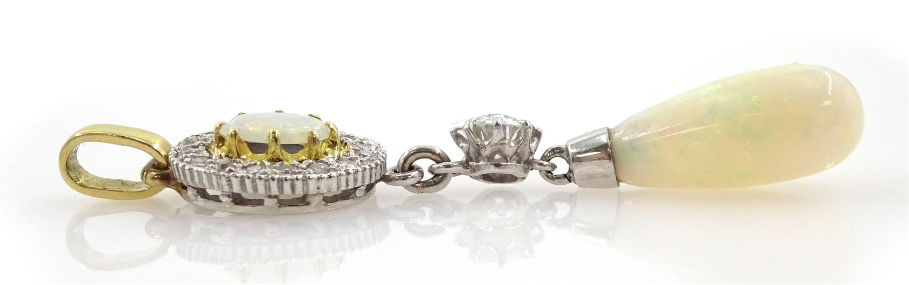 Gold and platinum opal and diamond pendant, the pear shaped opal cabochon suspending from a single old cut diamond of approx 0.20 carat and an opal and diamond cluster