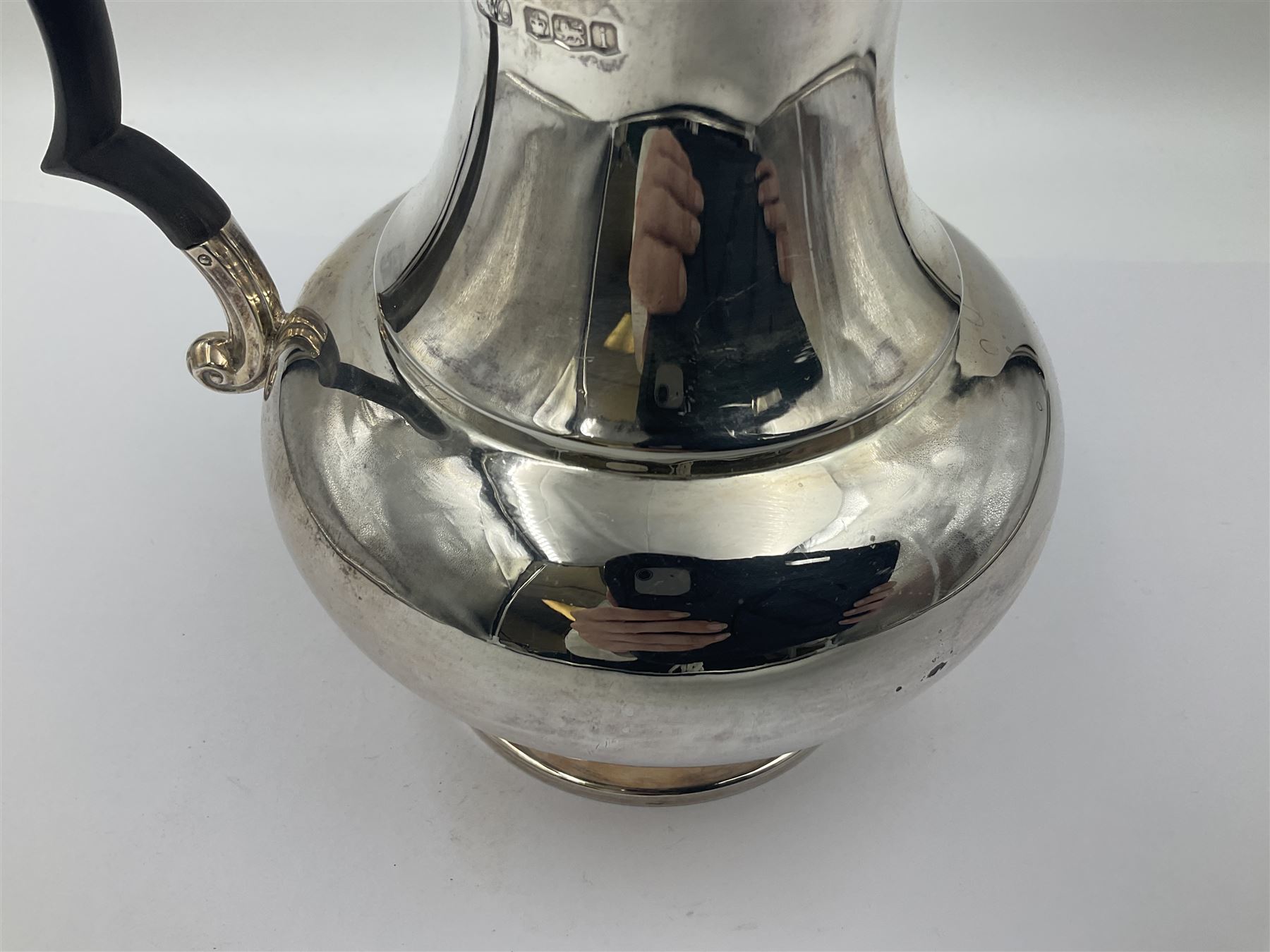 1920s five-piece silver tea service, comprising teapot, coffee pot, hot water pot, twin handled open sucrier and milk jug, each of squat circular form with shaped rim, the teapot, coffee pot and hot water pot each with ebonised handle and finial, the sucrier and milk jug with acanthus capped scroll handles, all upon circular foot, hallmarked R F Mosley & Co, Sheffield 1926 & 1927, tallest H24cm