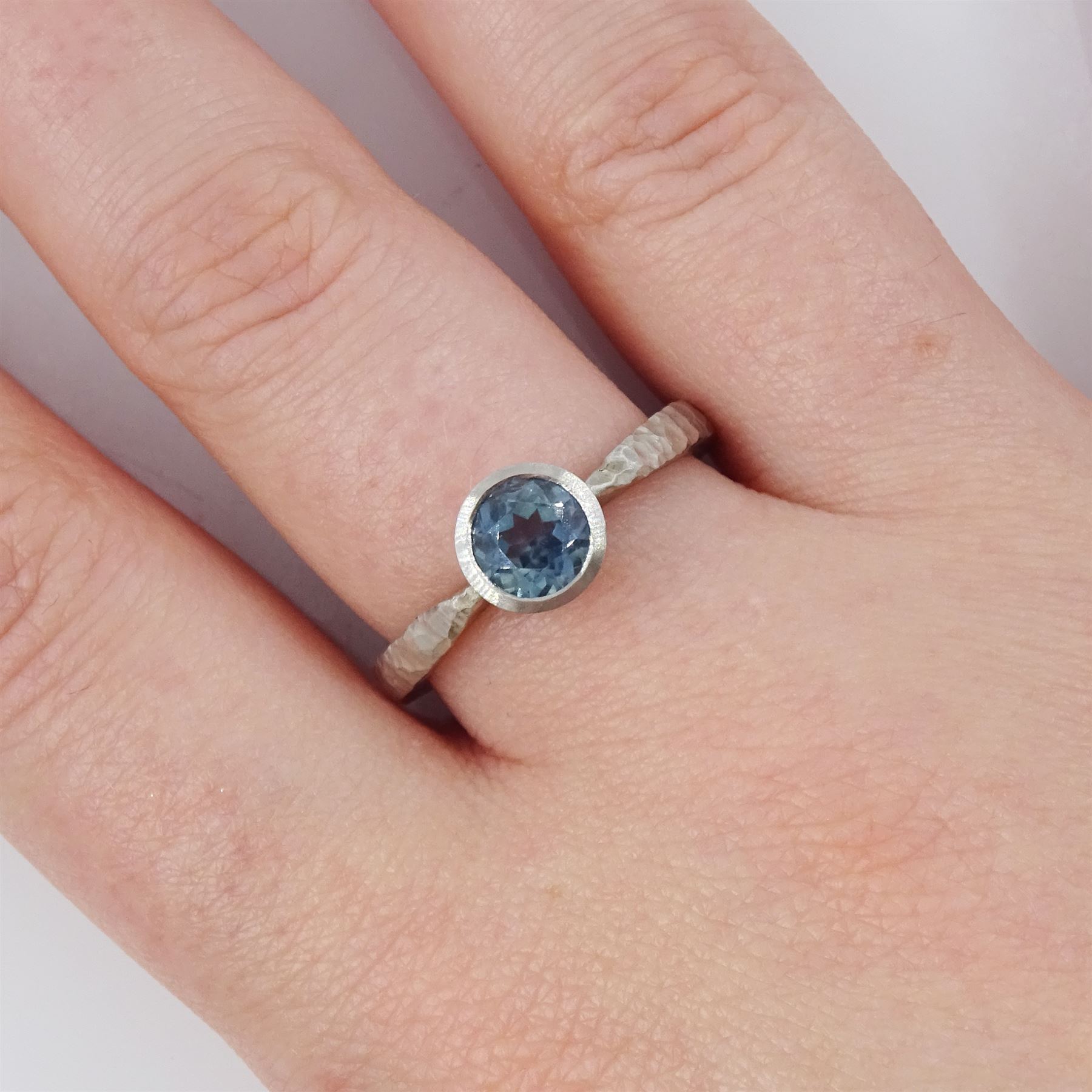 Platinum sapphire ring, single bezel set sapphire of approx 1.00 carat, to a planished shank, London 2019