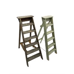 Early 20th century pine library or shop step ladder, seven tread (W45cm H135cm); together with another similar with painted laurel green finish (H135cm)