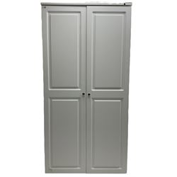 Large white finish sewing cabinet, enclosed by two doors fitted with thread holders and shelves, the interior fitted with shelves and sliding trays, with fold down work surfaces 