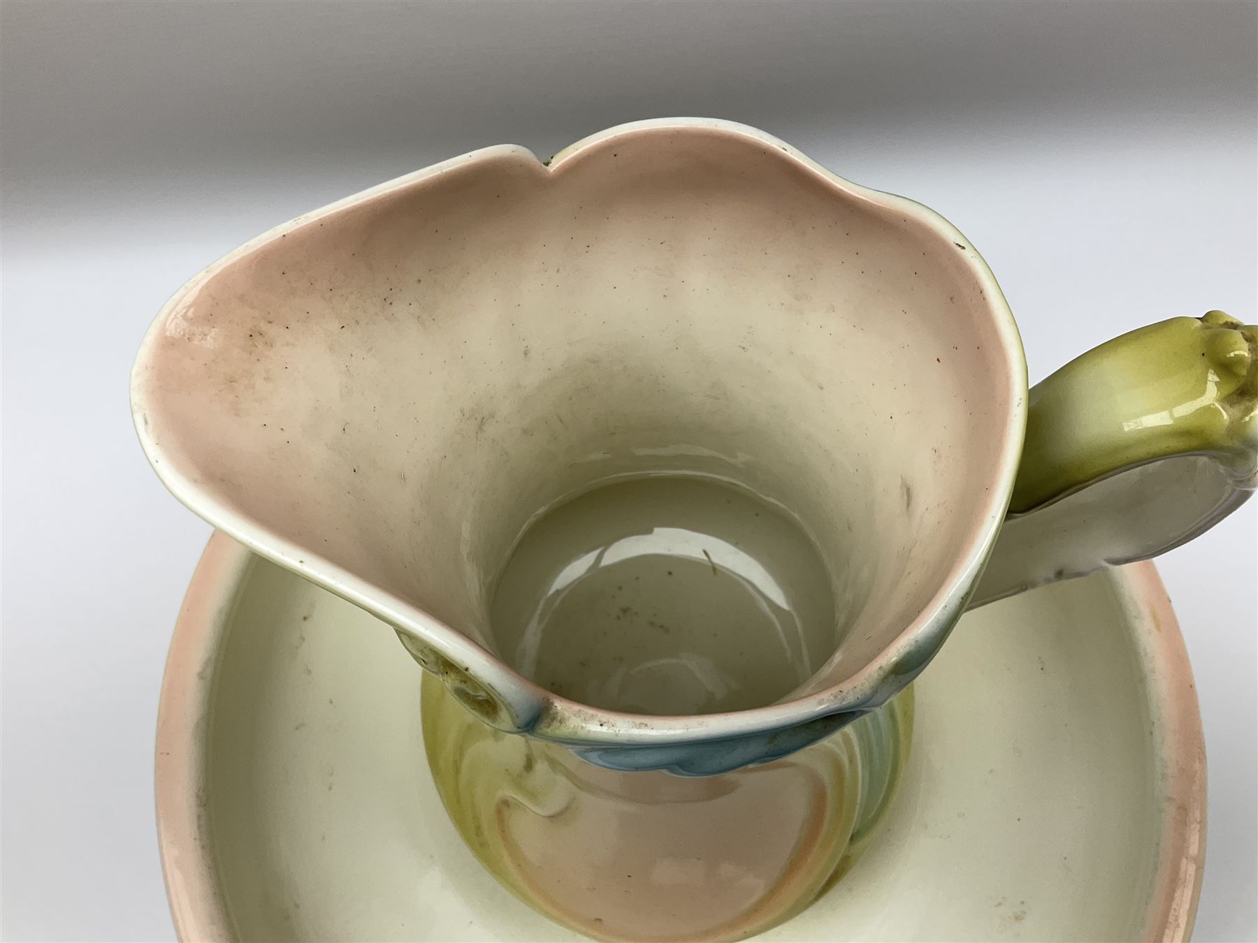 Wash jug and bowl with merging pink, green and blue decoration, bowl D40cm