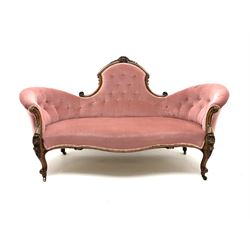 Victorian walnut serpentine framed settee, floral and scroll carving, upholstered in light rose buttoned fabric and detailed trim, shell carved supports and castors 